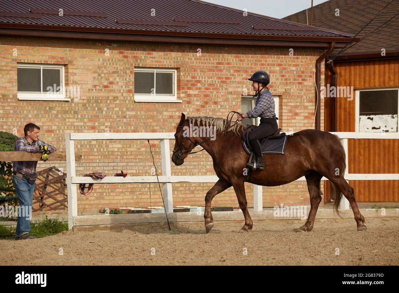 Girl rides a horse and smiles at dad - family leisure outdoors Stock ...