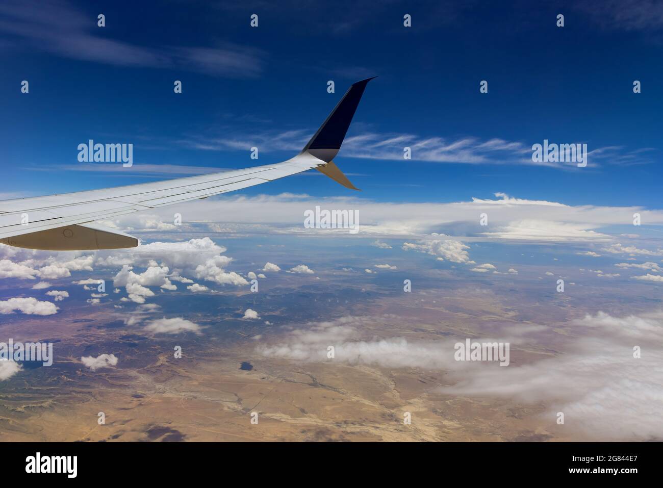 Aircraft in wing above white clouds in the sky of airplane Stock Photo ...