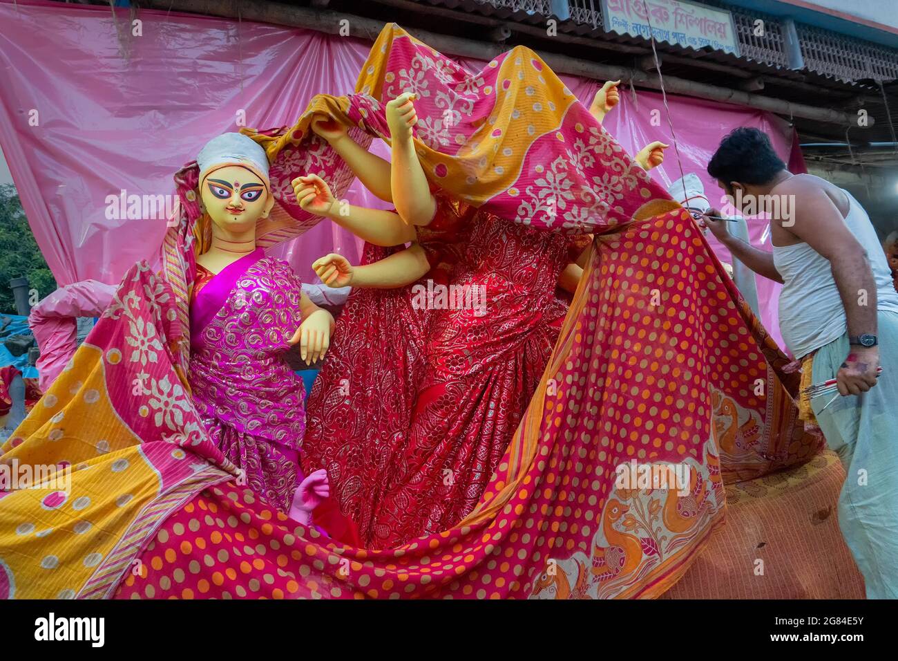Kolkata, West Bengal, India - 7th October 2018 : Clay idol of Goddess Durga and Saraswati, covered under Sari - traditional Indian dress for preparati Stock Photo