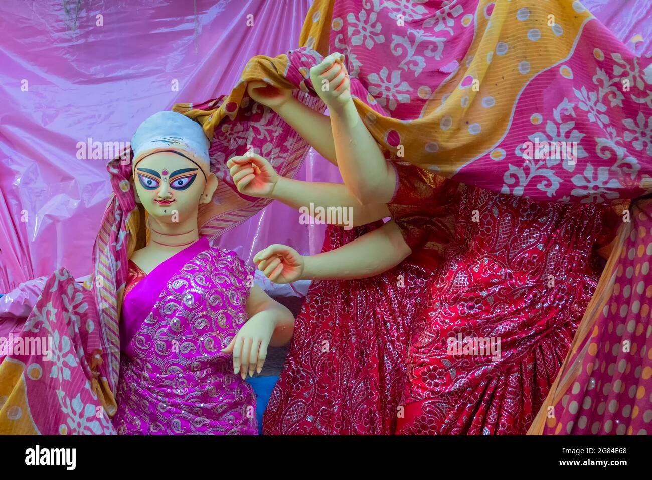 Kolkata, West Bengal, India - 7th October 2018: Clay idol of Goddess Saraswati and hands of Durga, covered under Sari - traditional Indian dress for p Stock Photo
