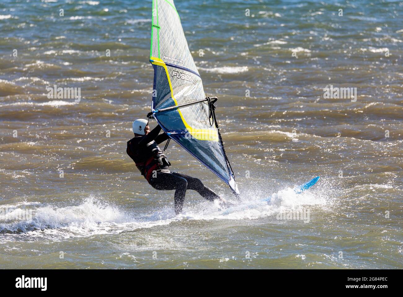 Australian man on his windsurfer at Pittwater in Sydney,Australia Stock Photo
