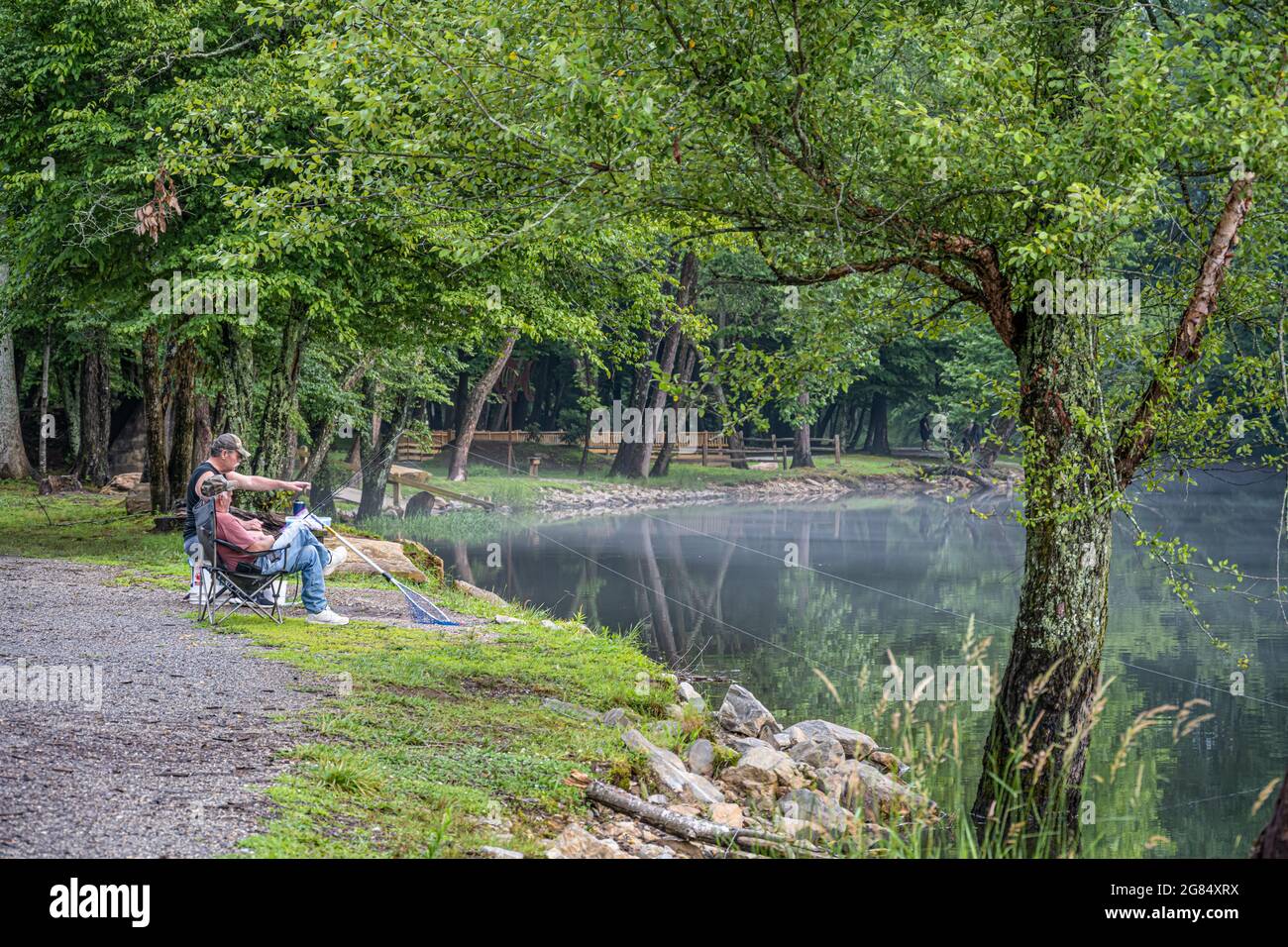 Fishermen enjoying a beautiful late afternoon on the misty Nottely River in the North Georgia Mountains at Meeks Park in Blairsville, Georgia. (USA) Stock Photo