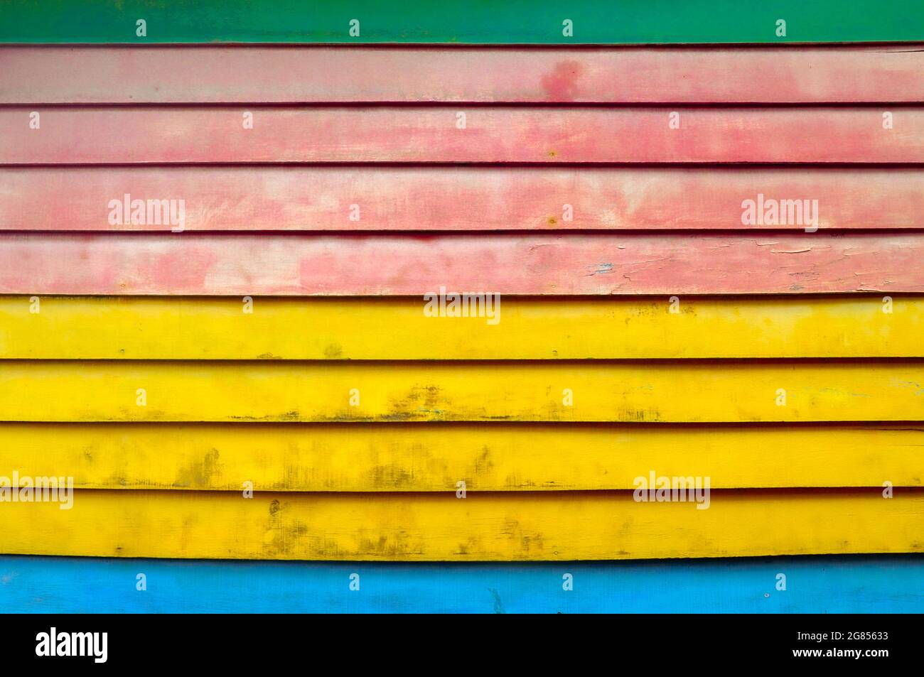 Colourful textured background of colourful, distressed horizontal wooden slats. Stock Photo