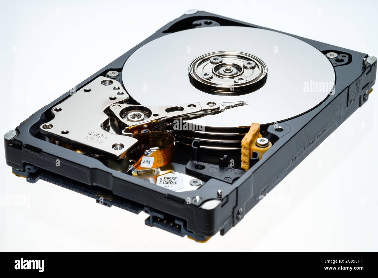 a computer's hard disk hdd data storage drive without shield show magnetic  disc and electronic part inside isolated in white background Stock Photo -  Alamy