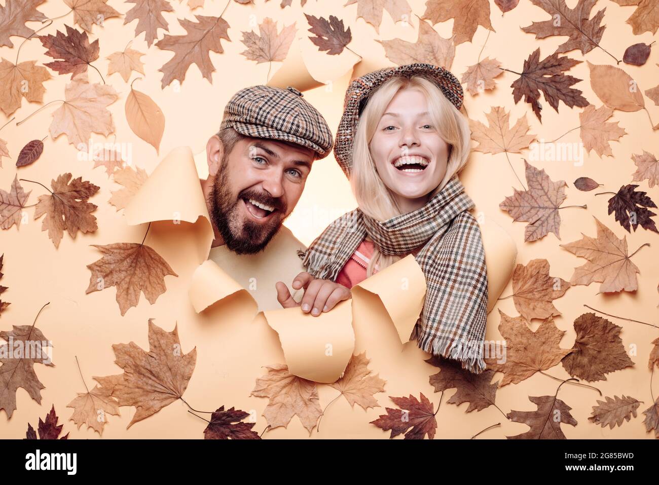 Funny couple are getting ready for autumn sale. Surprised couple on autumn  clothes discounts, bearded man and an attractive girl in yellow background  Stock Photo - Alamy