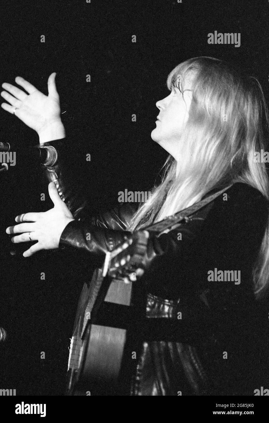black and white image of Christian rock musician, Larry Norman, performing at a concert in Brisbane, Australia, December 1982 Stock Photo