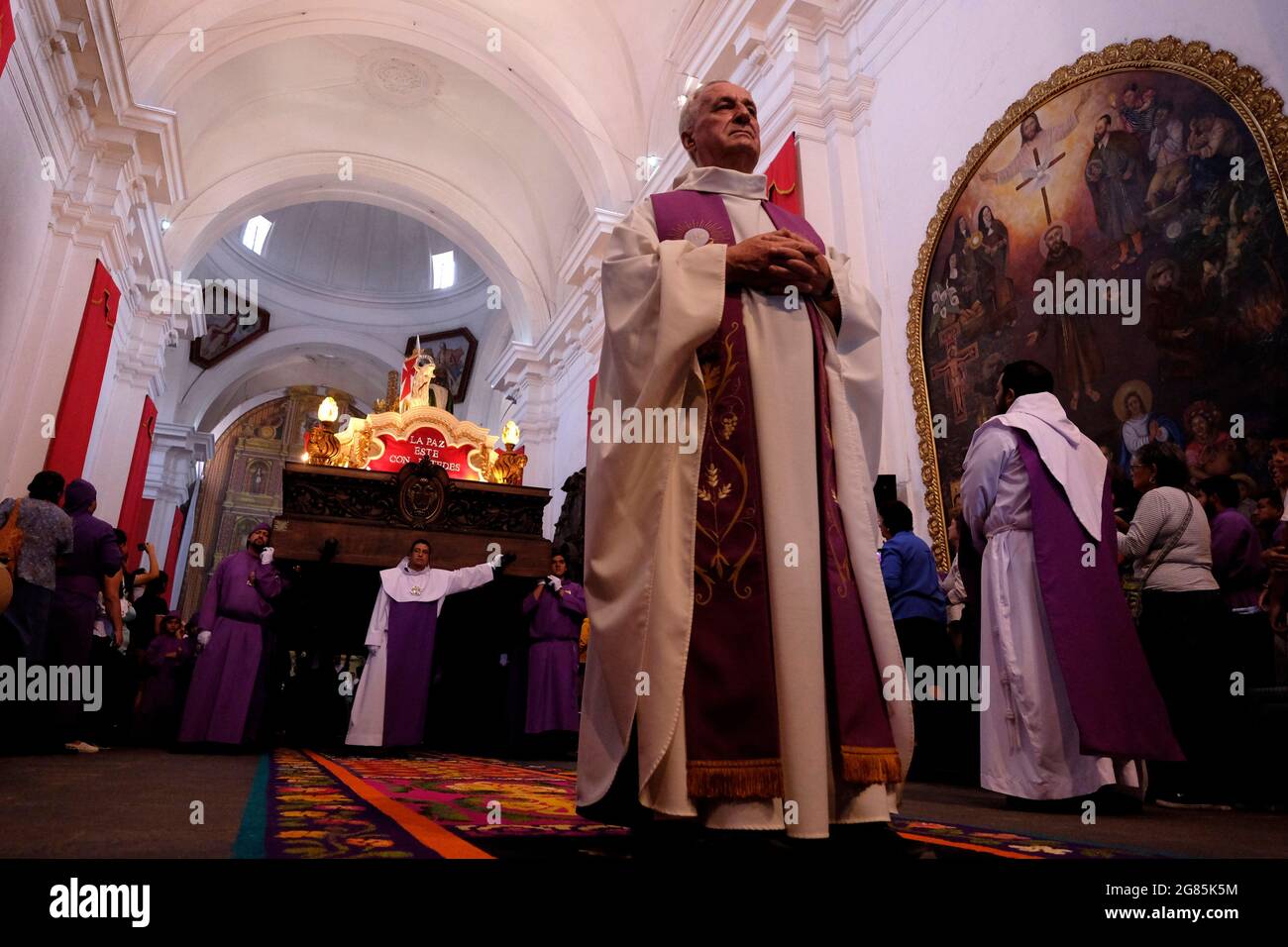 Catholic priests dressed in purple robes carrying the Anda (Float) of