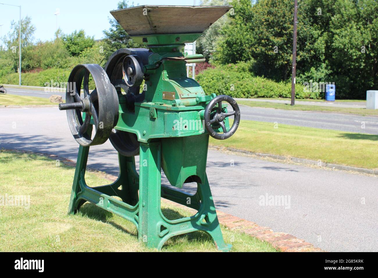 Old portable vintage grain and wheat crusher with wooden Hopper Stock Photo