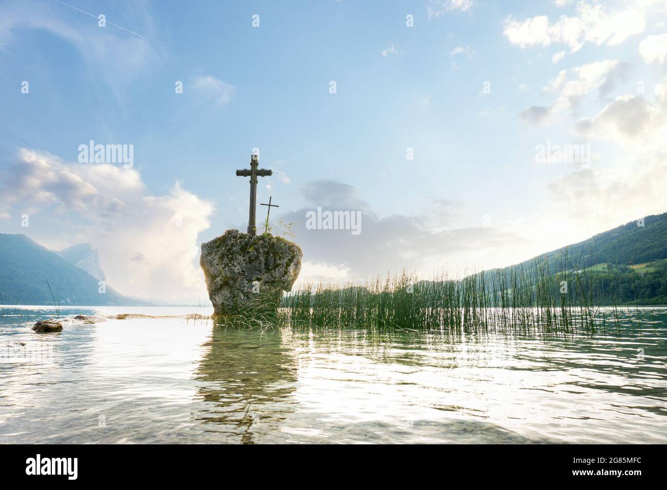 Lake Mondsee in the Salzkammergut during summer time. View to the cross on a rock in Upper Austria, Europe. Stock Photo