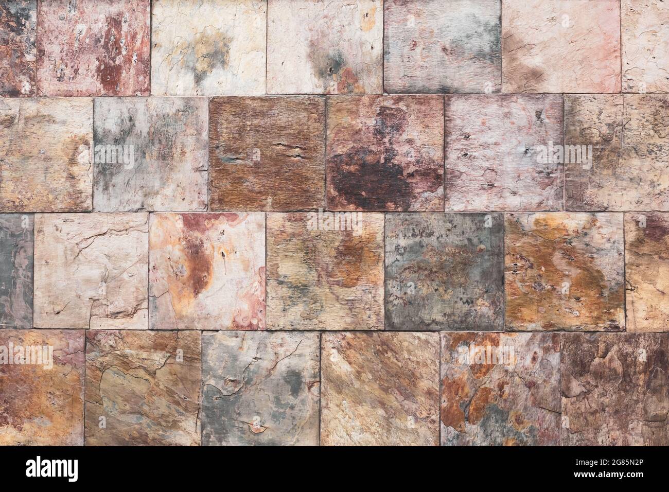 Brown old stone wall, vintage texture, bricks surface, abstract grunge background, square tile pattern, rough granite. Buildings facade. Textured rock Stock Photo