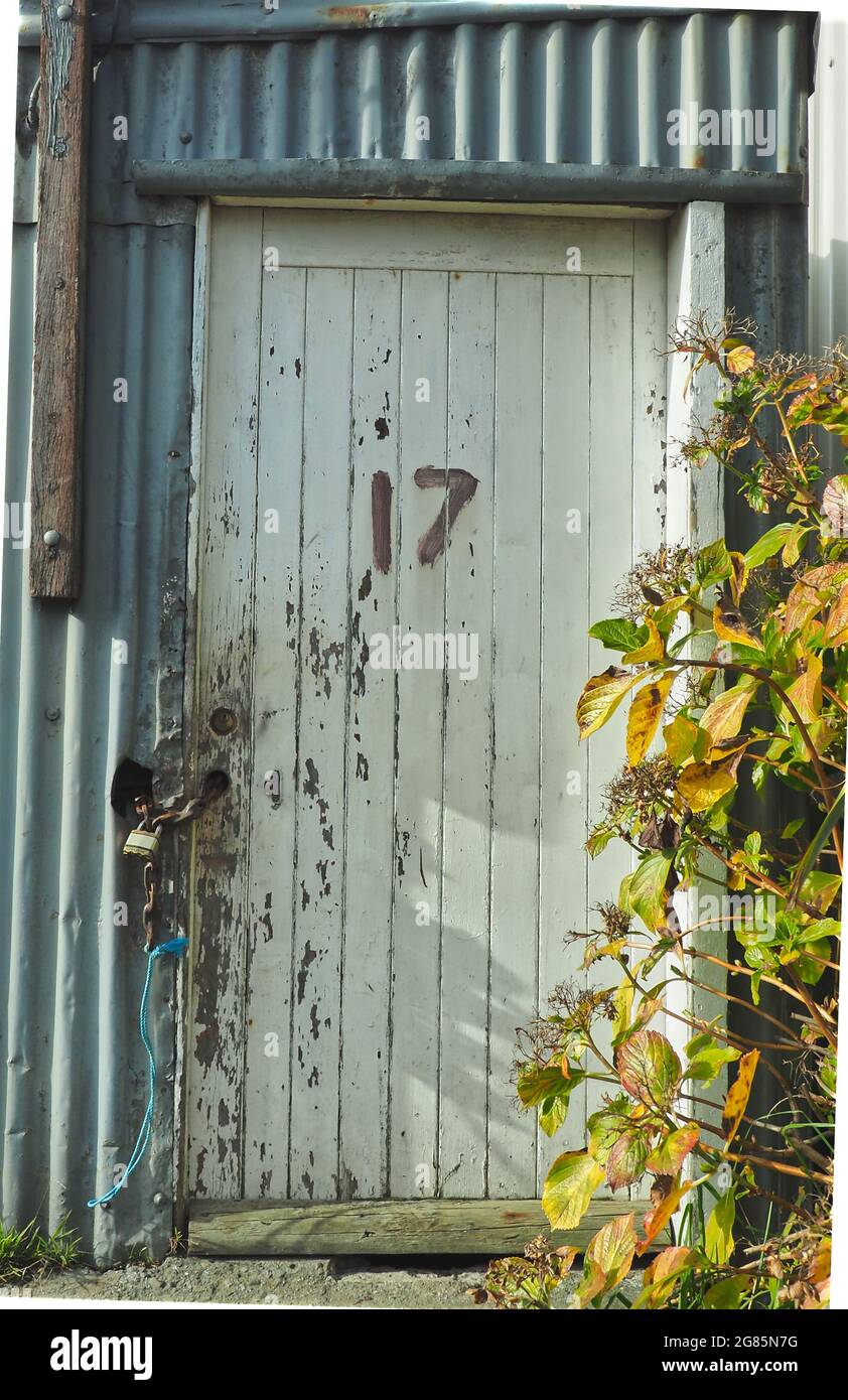 Mixed building materials and number 17 on the timber door of an old boat shed Stock Photo Alamy
