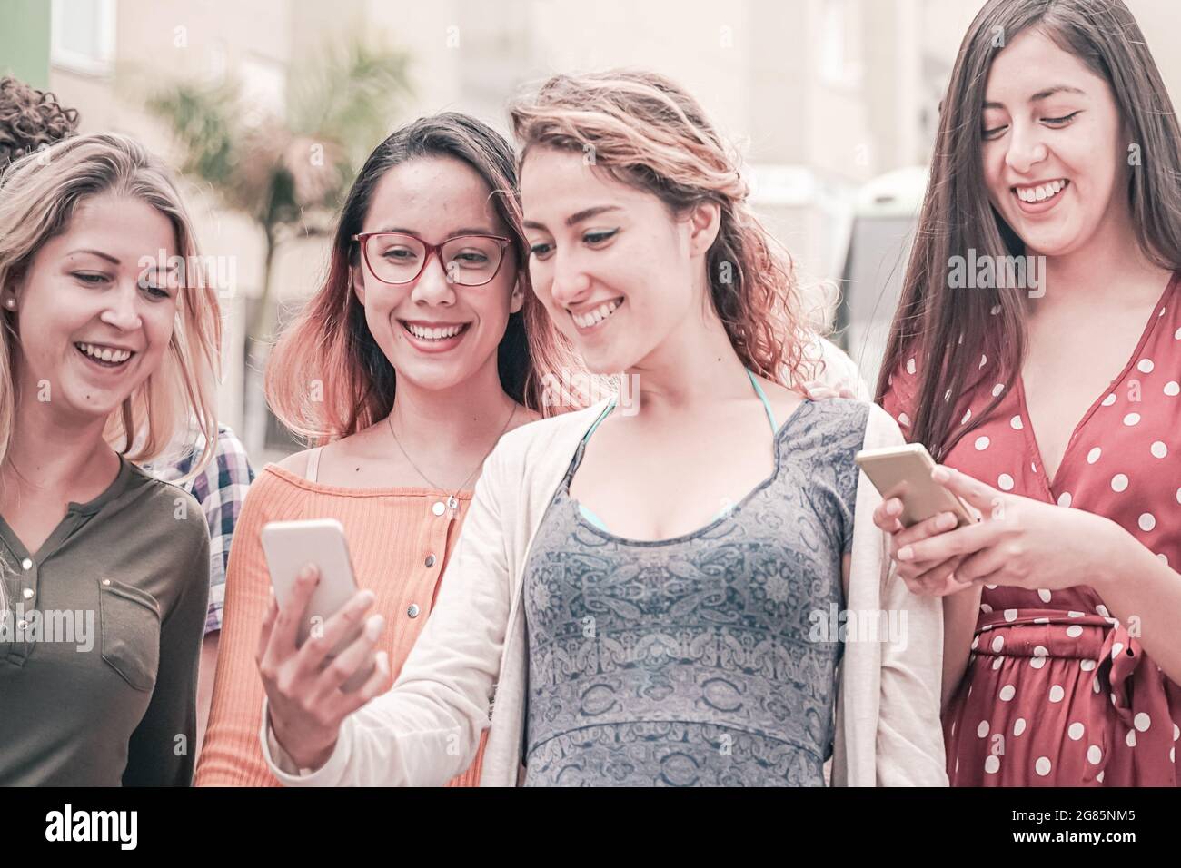 Young people walking and looking their smartphone. technology and friendship concept. Stock Photo