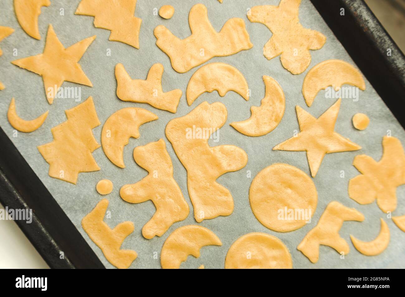 Christmas cookie cutter shapes on raw dough Stock Photo Alamy
