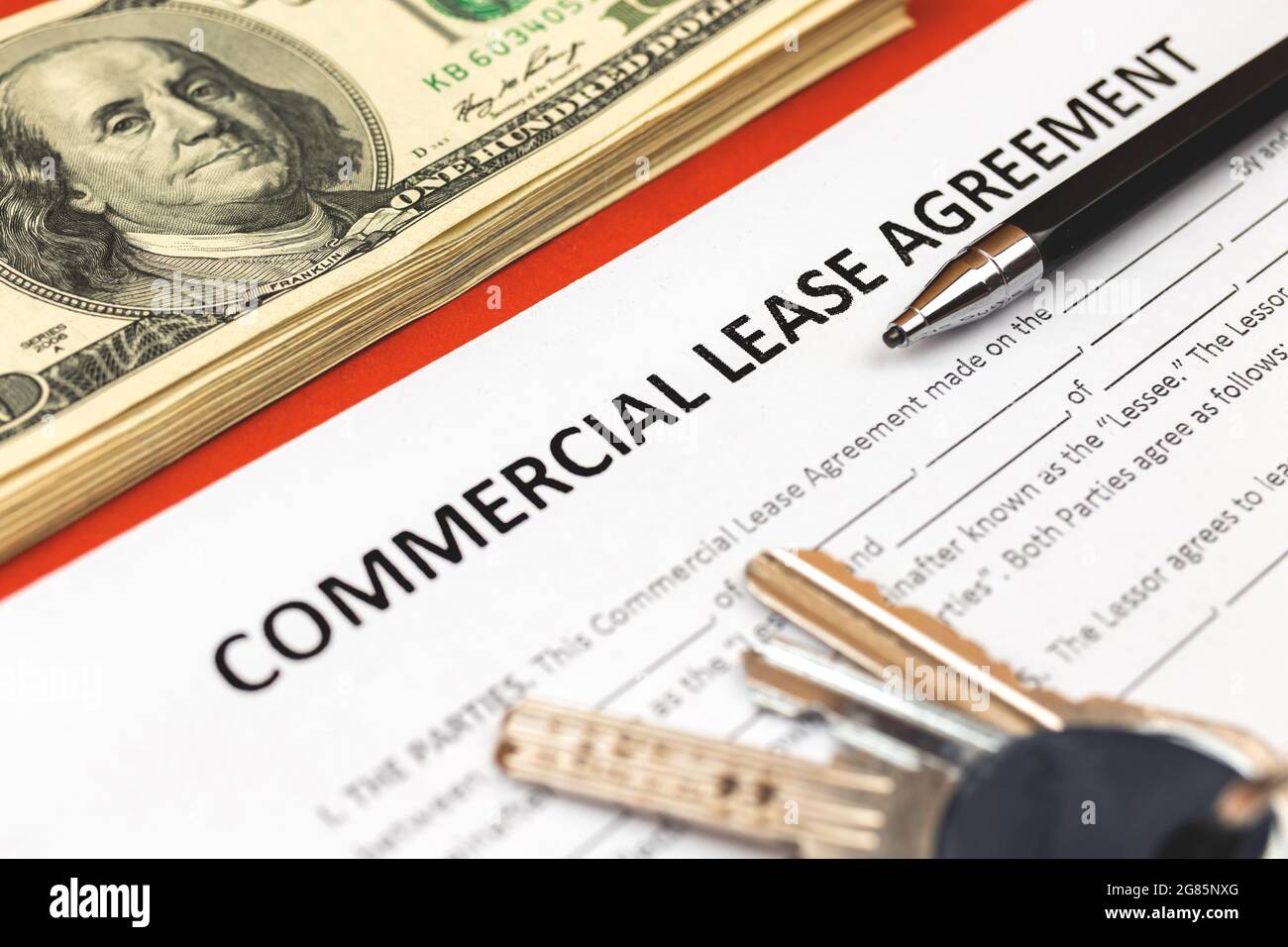 Commercial lease agreement form close-up. House keys, pen and money on ...