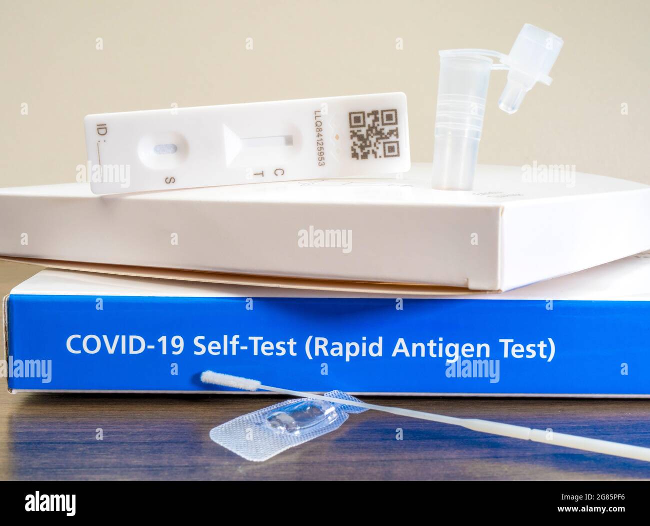 Closeup POV shot of an unbranded Covid-19 rapid antigen, self-test kit, with the contents of one test laid out ready to be used. Stock Photo