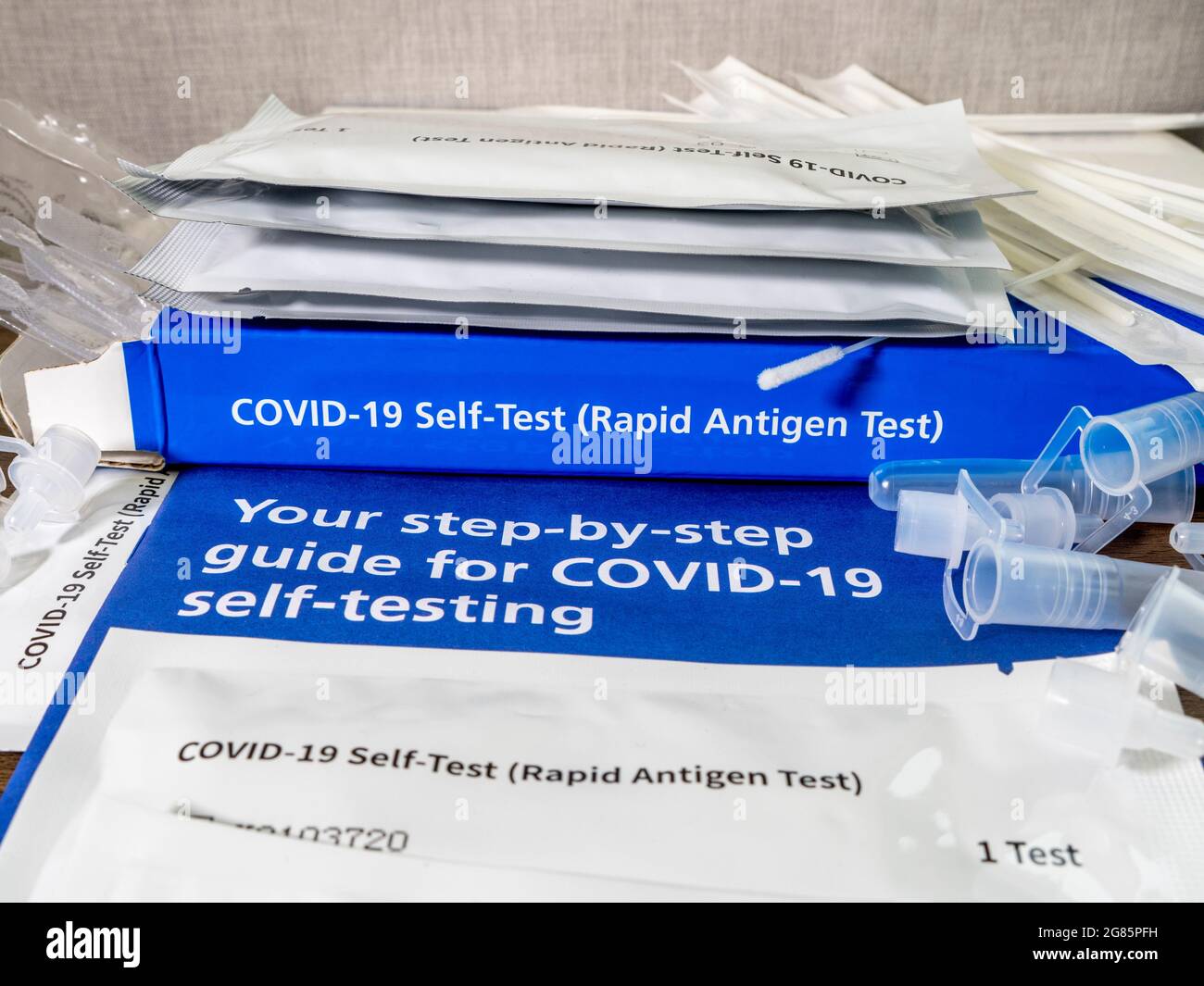 Closeup POV shot of an unbranded Covid-19 rapid antigen, self-test kit, with contents and user guide laid out. Stock Photo