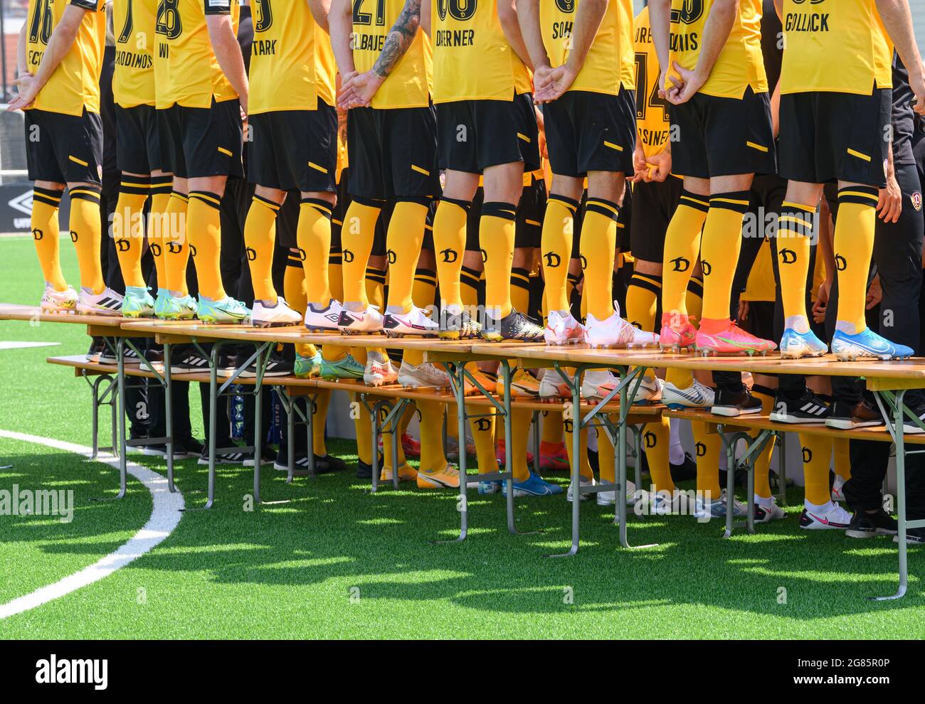Dresden, Germany. 16th July, 2021. Football: 2. league, team photo session, SG Dynamo Dresden, season 2021/2021, at the Aok Plus Walter-Fritzsch-Akademie. The players are standing on beer tables. Credit: Robert Michael/dpa-Zentralbild/dpa - IMPORTANT NOTE: In accordance with the regulations of the DFL Deutsche Fußball Liga and/or the DFB Deutscher Fußball-Bund, it is prohibited to use or have used photographs taken in the stadium and/or of the match in the form of sequence pictures and/or video-like photo series./dpa/Alamy Live News Stock Photo