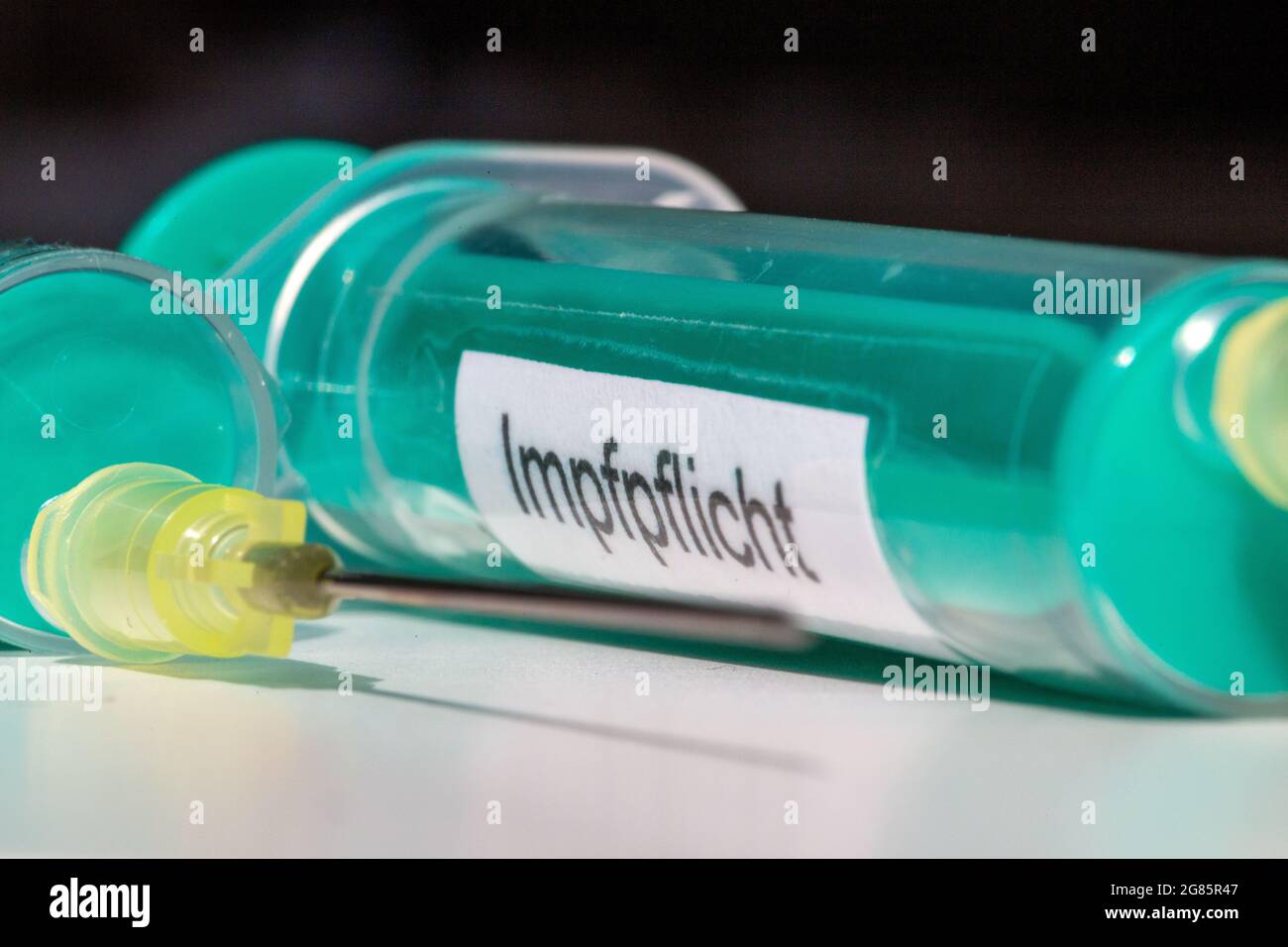 Hypodermic needle with the inscription Impfpflicht (mandatory vaccination), symbolic image Stock Photo