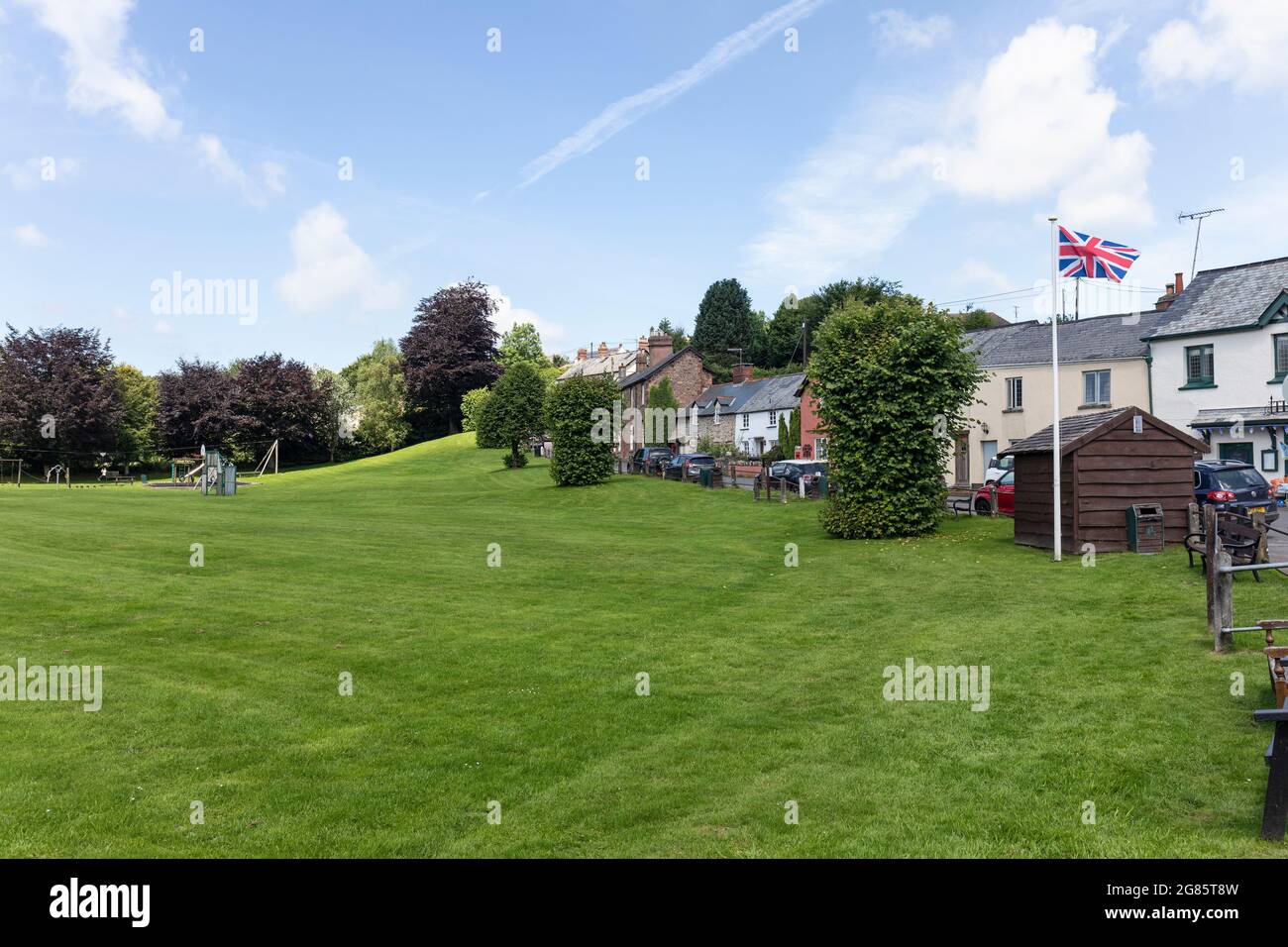 Exford village green with a Union Jack flag flying, Exmoor National Park, Somerset, England, UK Stock Photo