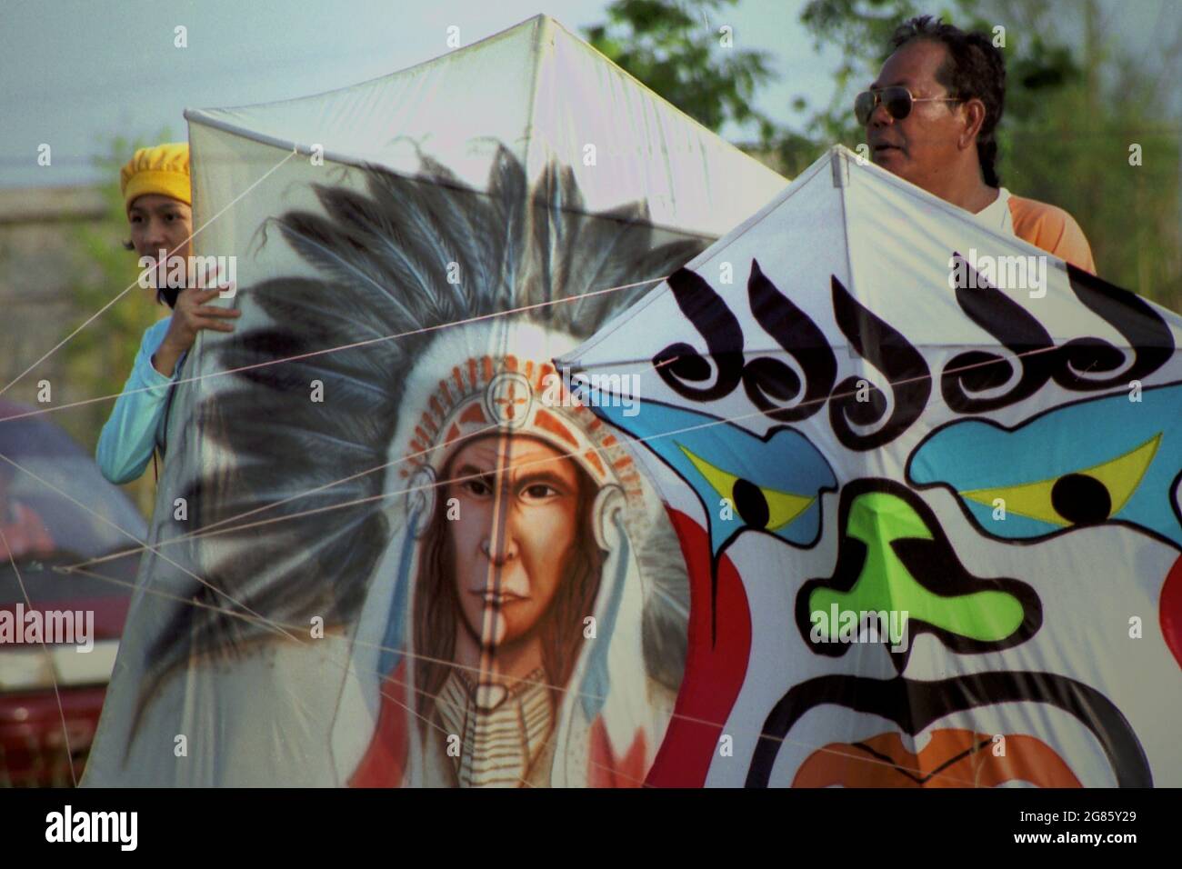 People holding kites during the 2004 Jakarta International Kite Festival that held on July 9-11 at Carnival Beach in Ancol Dreamland, North Jakarta, Jakarta, Indonesia. Stock Photo