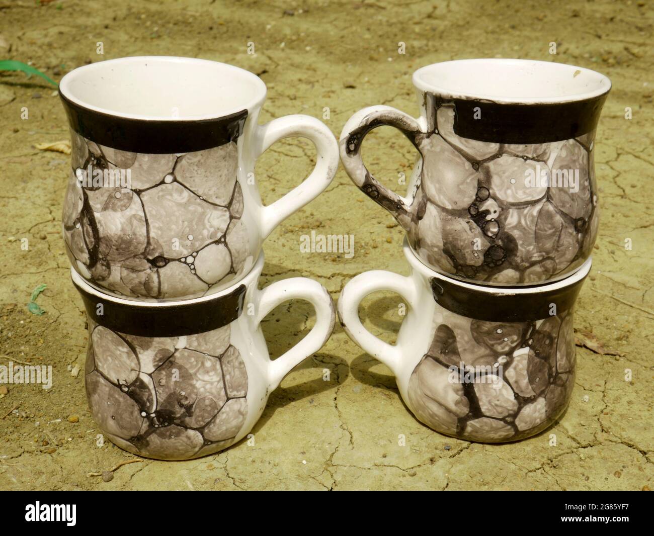 China soil tea cup collection presented on soil field, kitchen cutlery