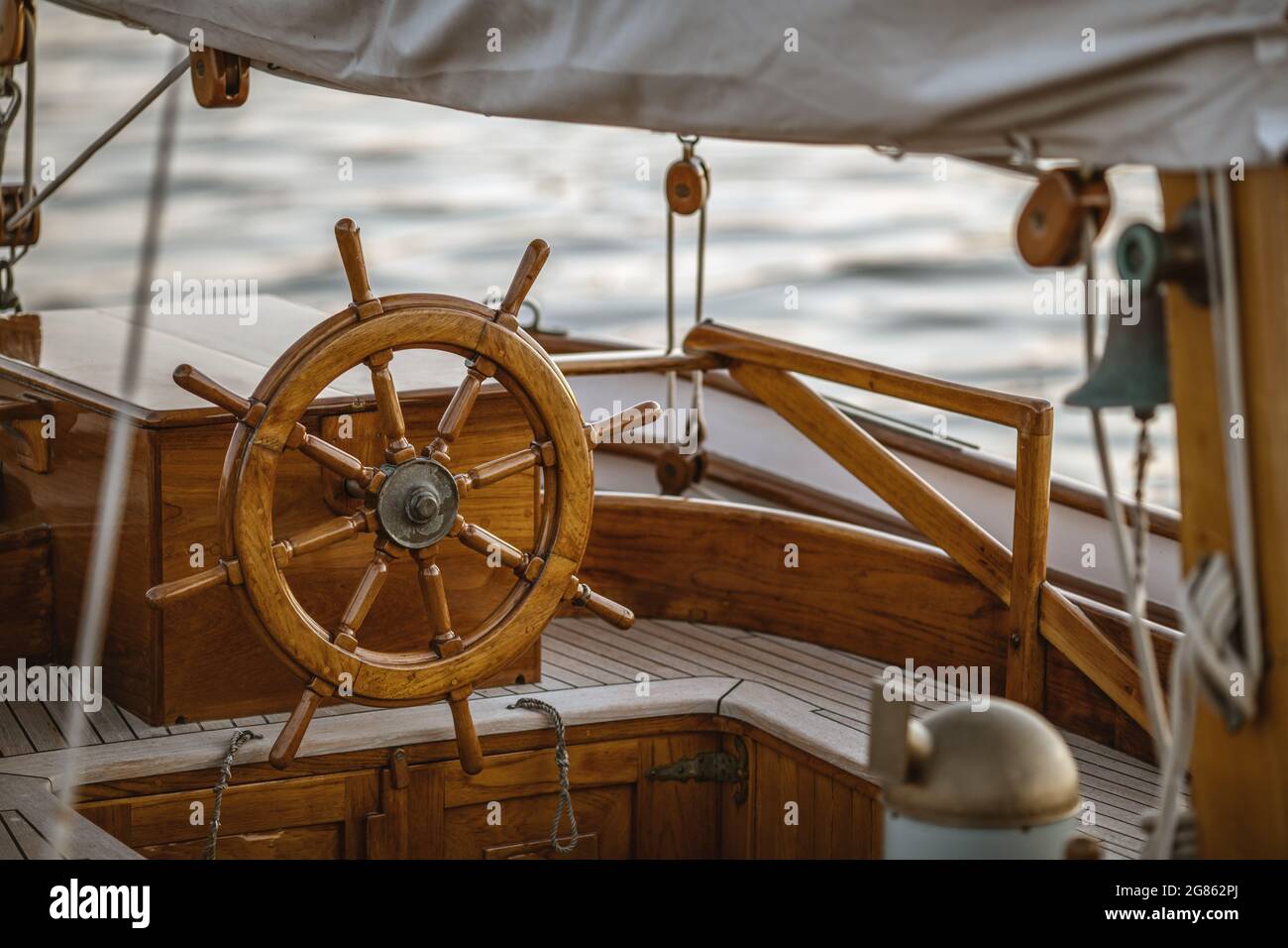 A close-up of instruments and wooden wheel of nautical vessel. Sailboat ...