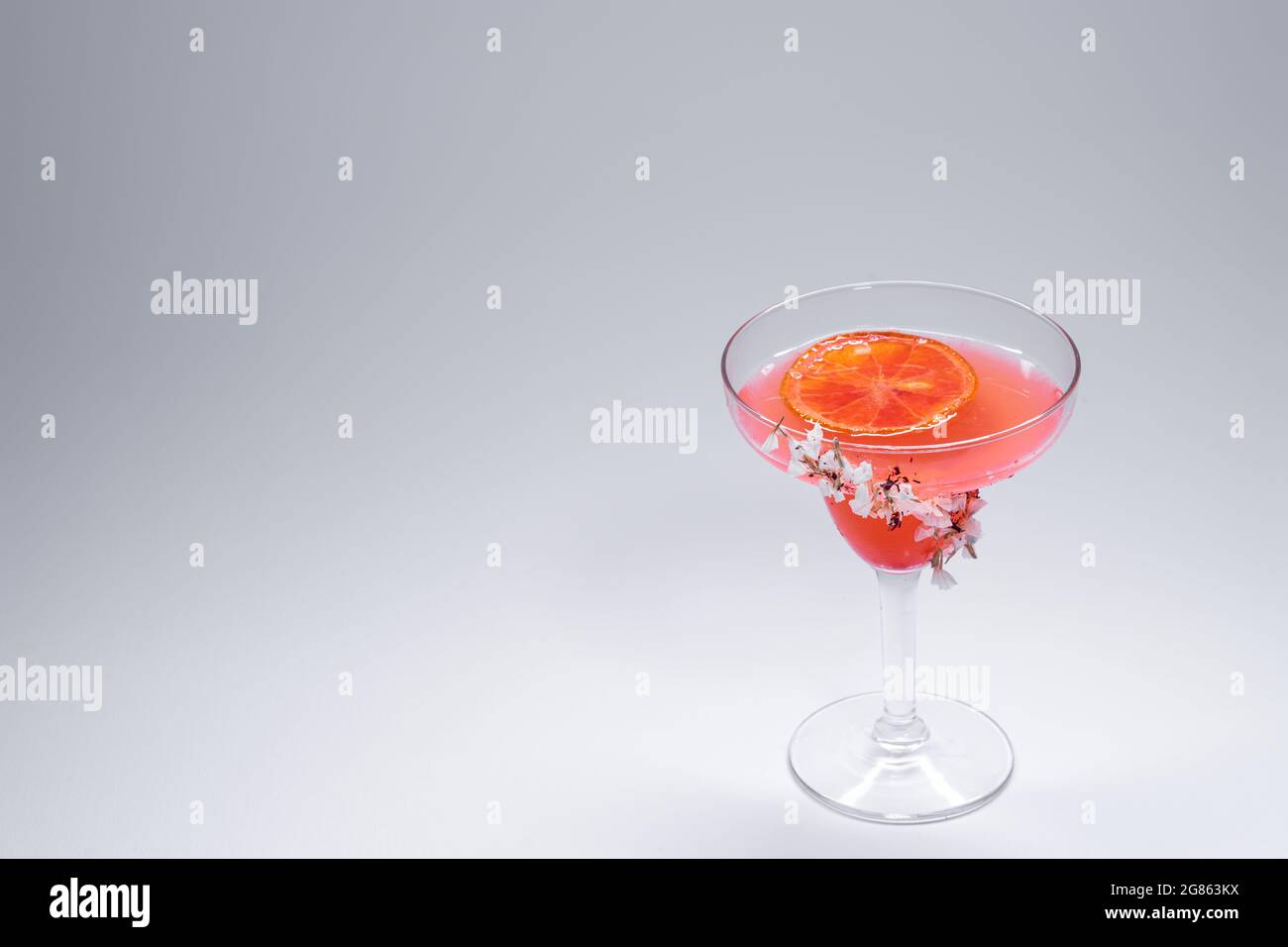 hemingway daiquiri cocktail drink with grapefruit in glass on white