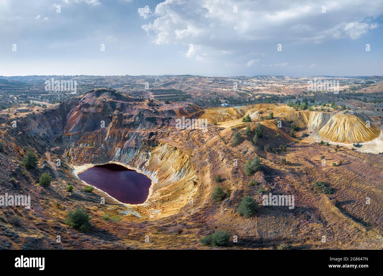 Toxic lake in abandoned open pit copper mine and waste heaps near Kampia, Cyprus. Aerial panorama Stock Photo