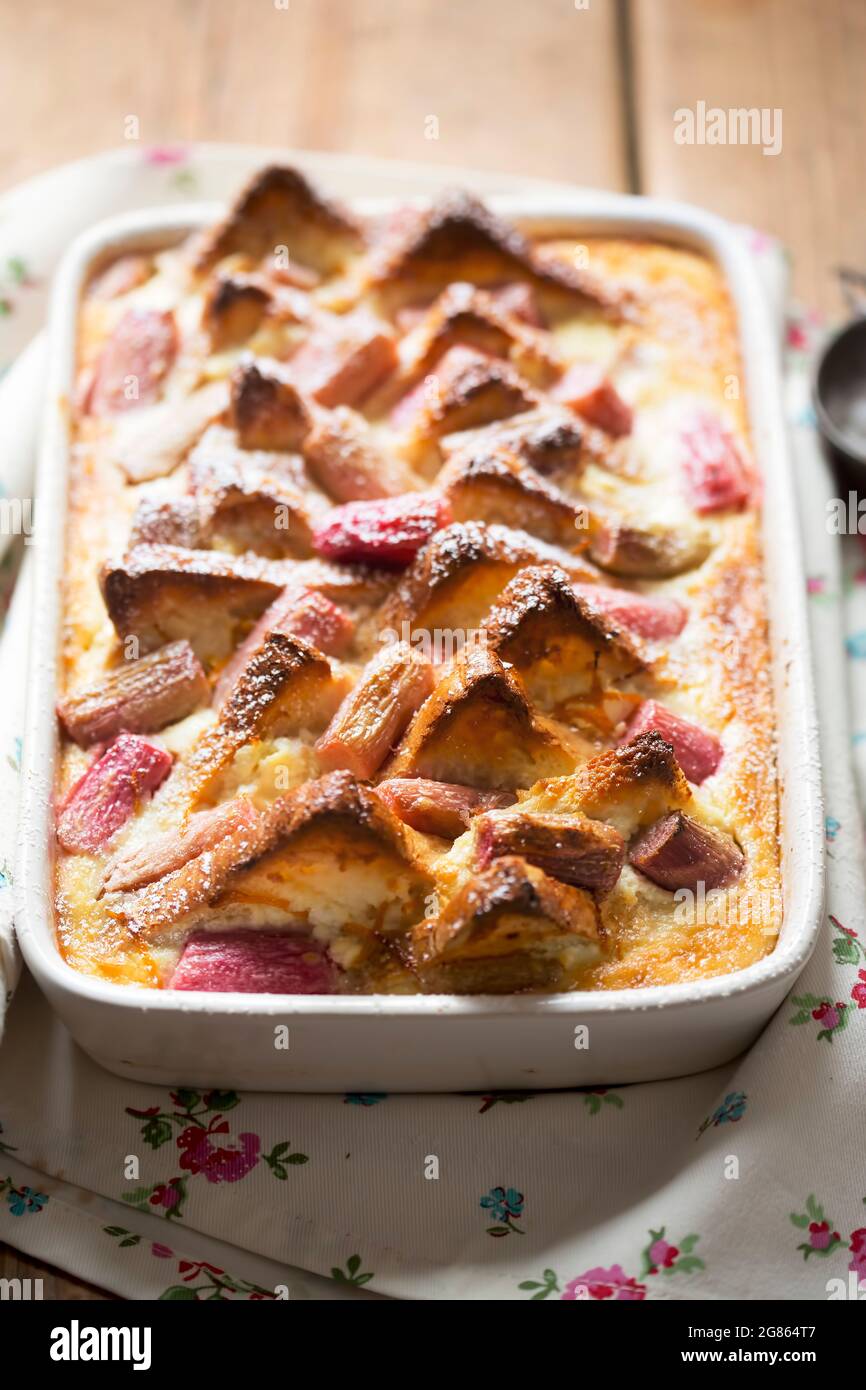 Rhubarb ricotta bread and butter pudding with icing sugar Stock Photo