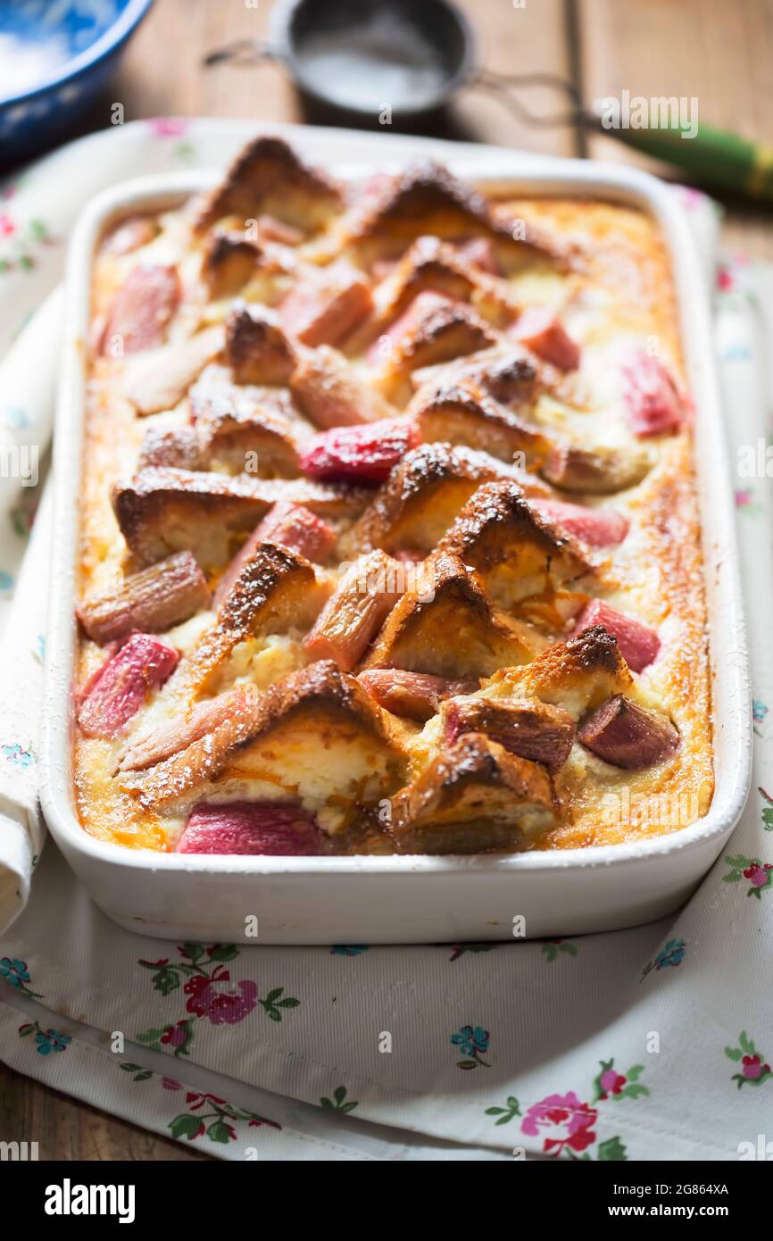 Rhubarb ricotta bread and butter pudding with icing sugar Stock Photo
