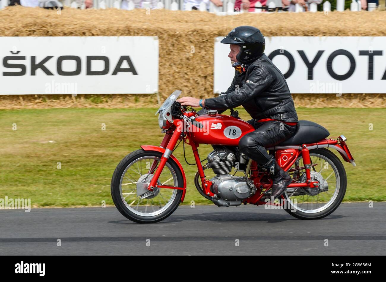 1955 Ducati 100 Gran Sport motorcycle racing up the hill climb at the Goodwood Festival of Speed 2013. 1950s sporting motorbike Stock Photo