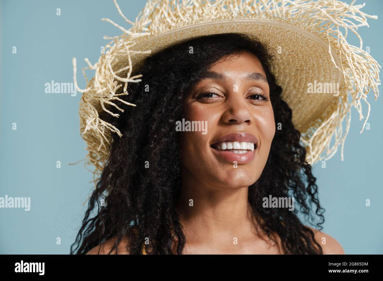 Black woman in straw hat smiling and looking at camera isolated over ...