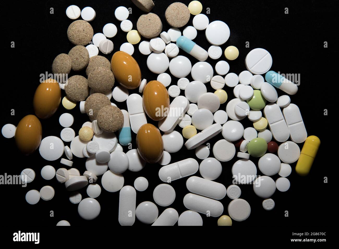 various pills on a black background Stock Photo
