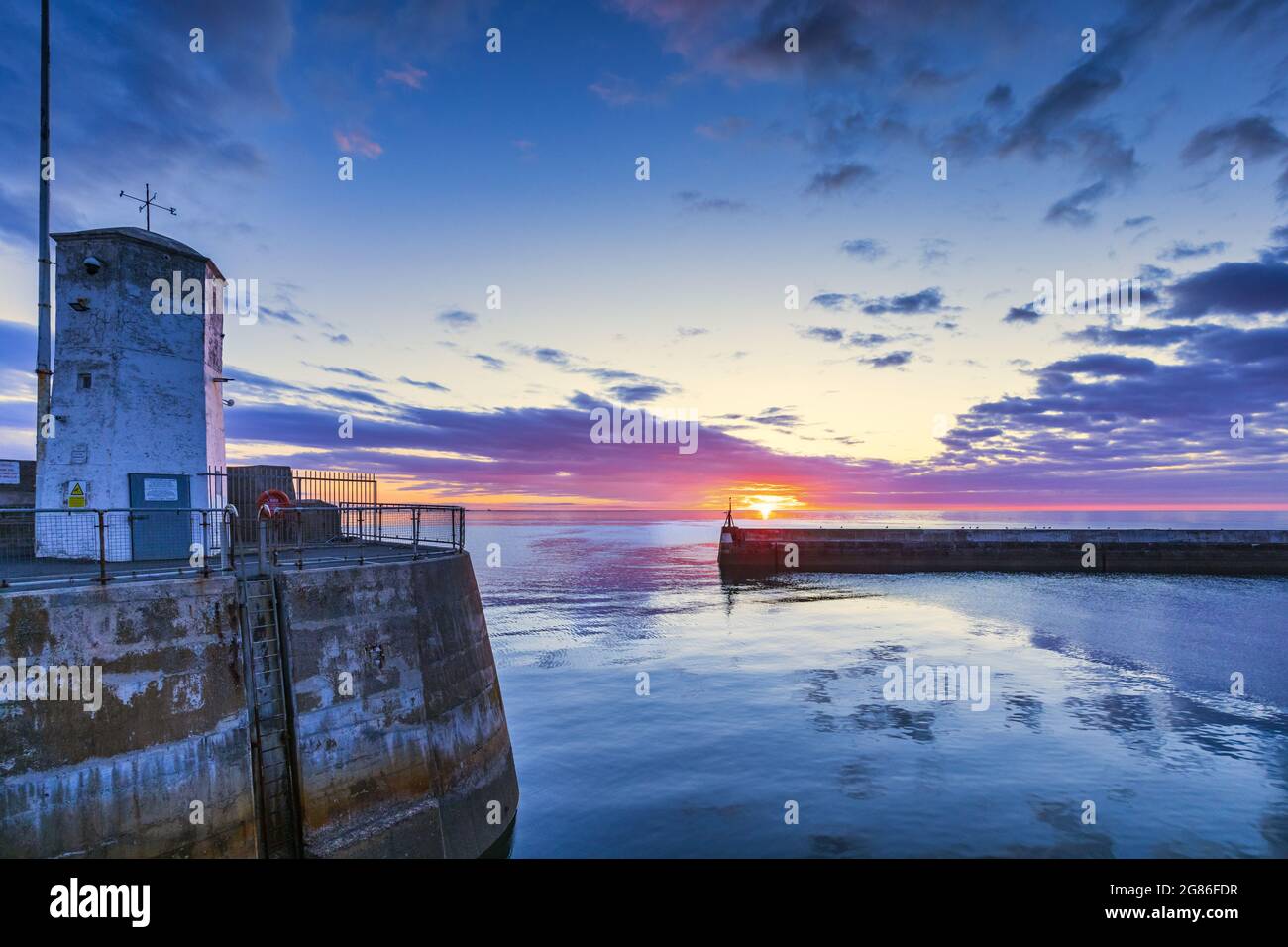 A colourful sunrise at Seahouses harbour on the Northumberland coast in England, Uk. Stock Photo