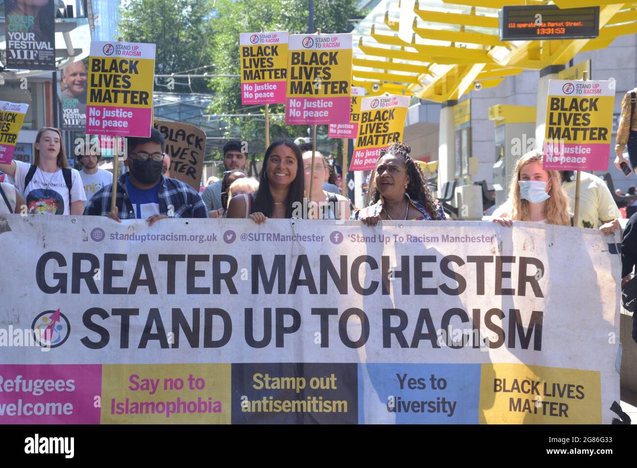 Manchester, UK.  17th July 2021. A lively and vocal Black Lives Matter protest of some 120 people marched from St Peter's Square to the Football Museum in central Manchester. This follows the online racist abuse of black footballers in the England football team, with the protest having a theme of solidarity with England football players: Marcus Rashford, Bukayo Saka and Jadon Sancho. The group took the knee in the road by the Football Museum, blocking the traffic for 20 minutes. Credit: Terry Waller/Alamy Live News Stock Photo