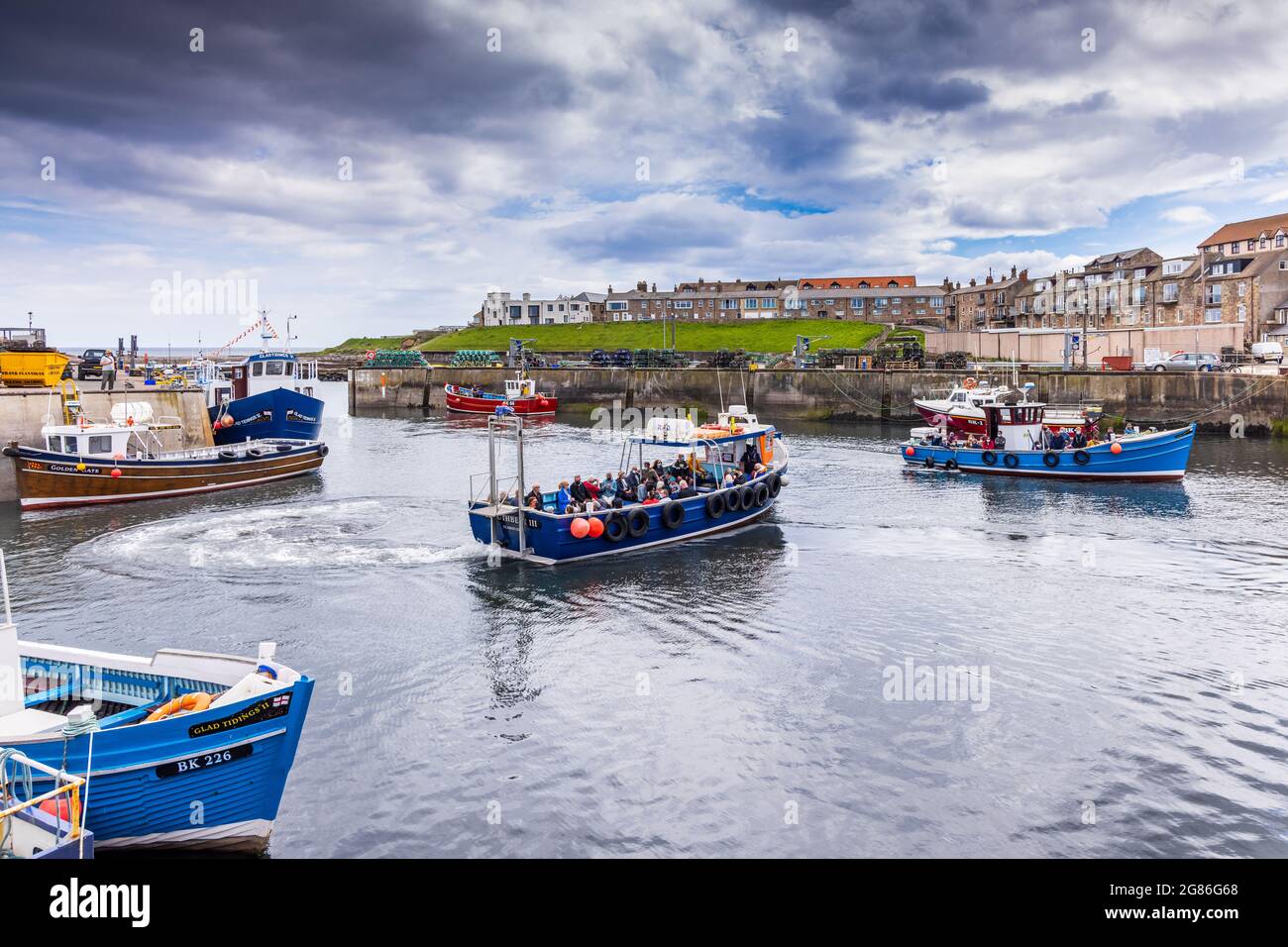 Seahouses Harbour in Northumberland,  home to a small fishing fleet and boats taking trips to the nearby Farne Islands. Stock Photo