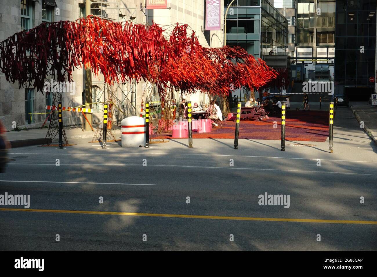 Montreal, QC, Canada - 7-14-2021: The Urban Forest at the street next to McCord museum, Sherbrooke street west with people enjoying their time after t Stock Photo