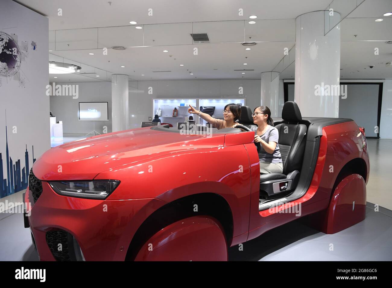 (210717) -- BAODING, July 17, 2021 (Xinhua) -- Visitors try 5G-based intelligent driving technology at the Haval technology center of Great Wall Motor (GWM) in Baoding, north China's Hebei Province, July 15, 2021. More than 1.1 million new-energy cars have been registered in China in the first half of this year, a record high for the same period in any year, the Ministry of Public Security said on July 6.   The number represents an over 200 percent rise from the same period last year and accounts for nearly eight percent of the total car registrations.    GWM, China's leading sport utility veh Stock Photo