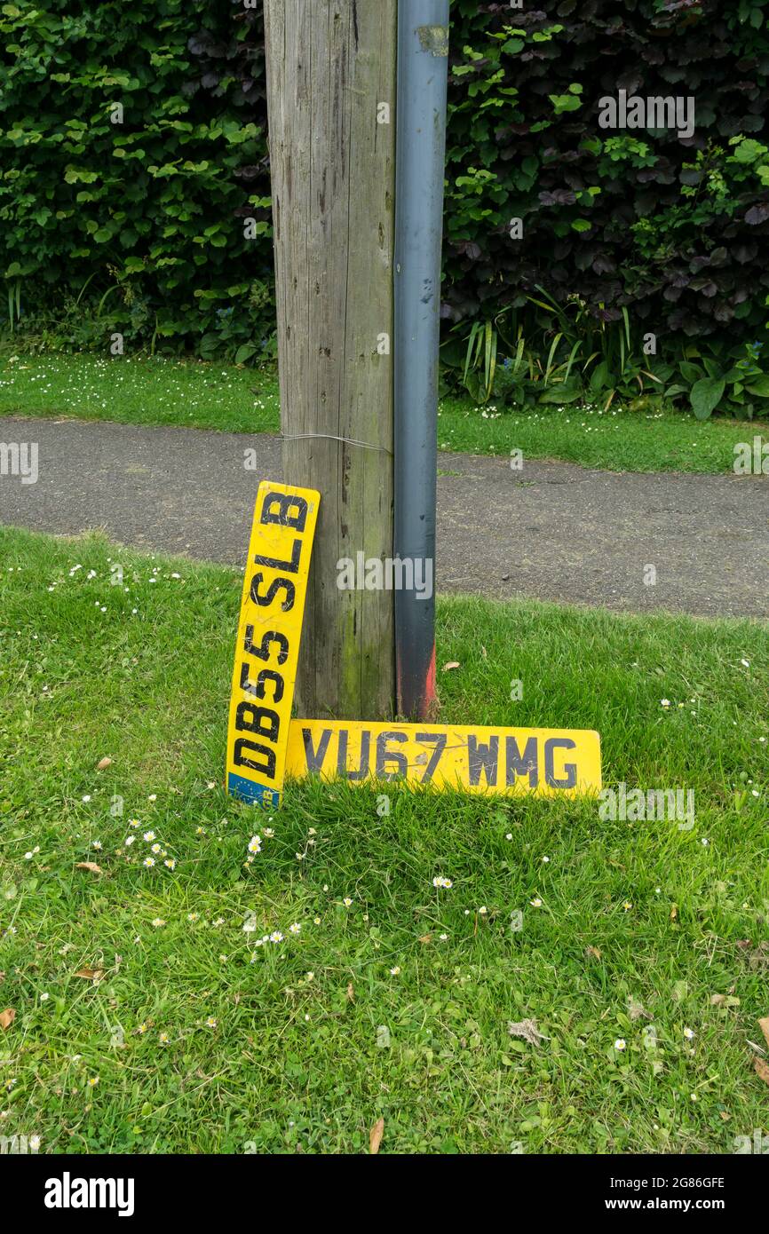 Lost or discarded number plates on grass verge. Stock Photo