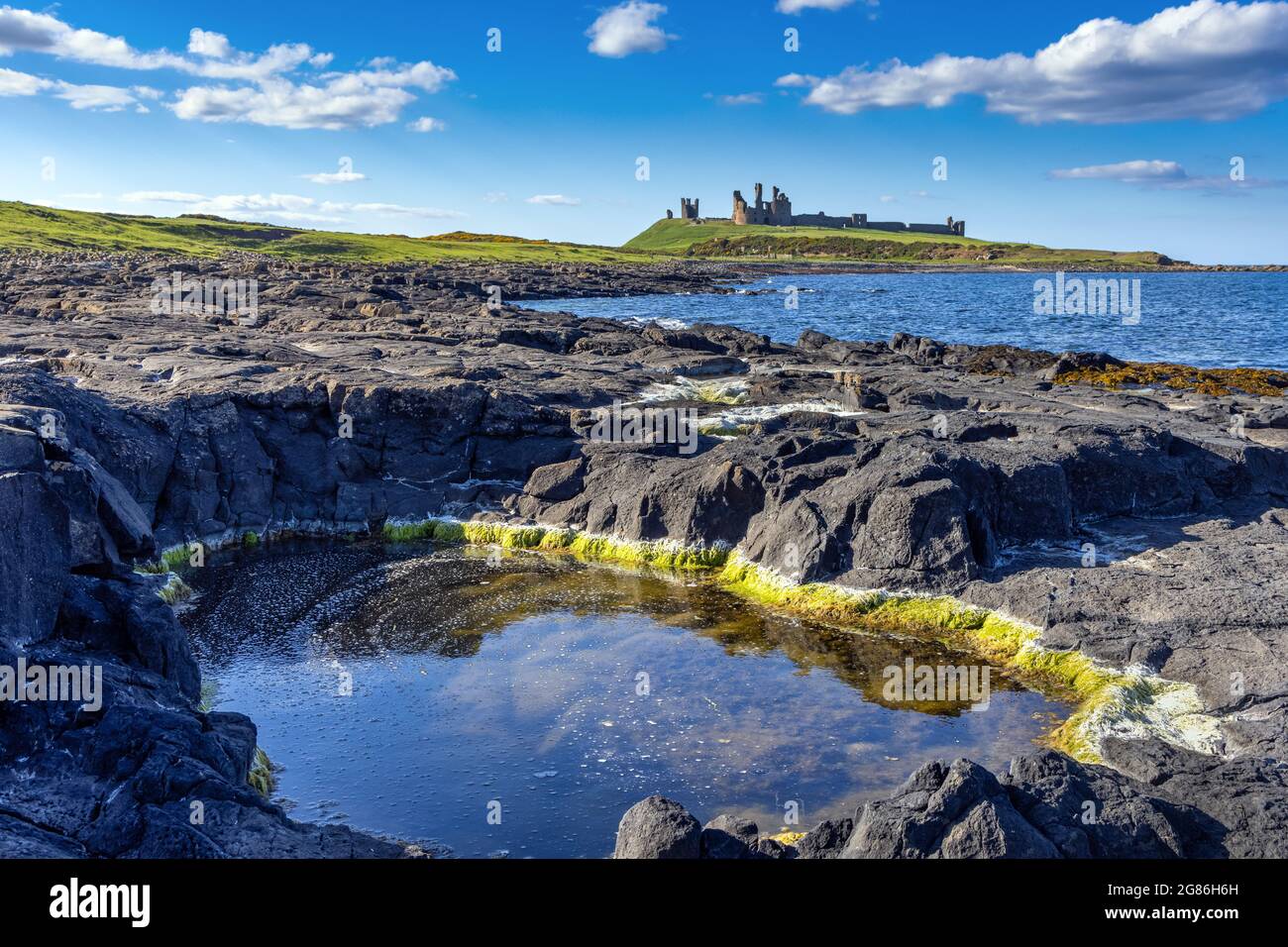The ruins of Dunstanburgh Castle on the coast of Northumberland, England UK Stock Photo