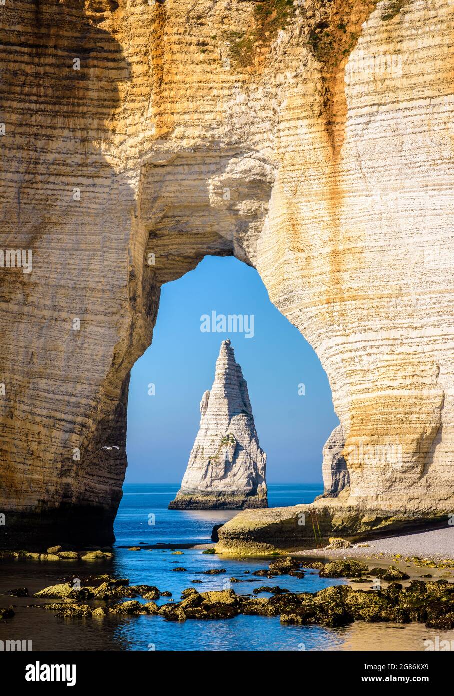 Close-up view of the Needle through the arch of the Manneporte cliff in ...