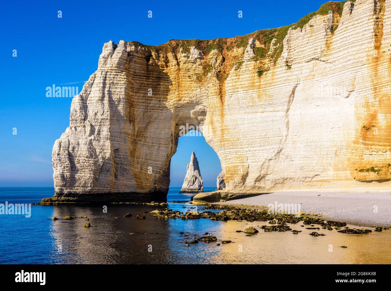 The Needle seen through the arch of the Manneporte cliff in Etretat ...