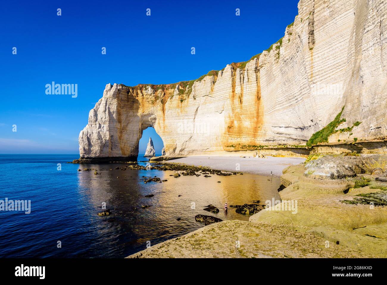 The Manneporte cliff with the Needle seen through the arch in Etretat ...