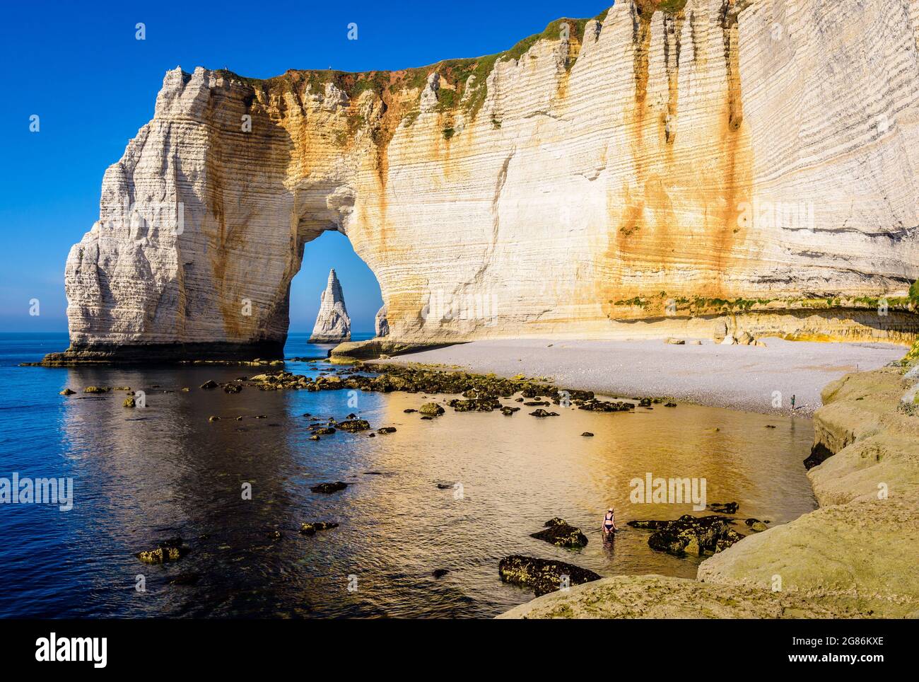 The Manneporte cliff with the Needle seen through the arch in Etretat ...