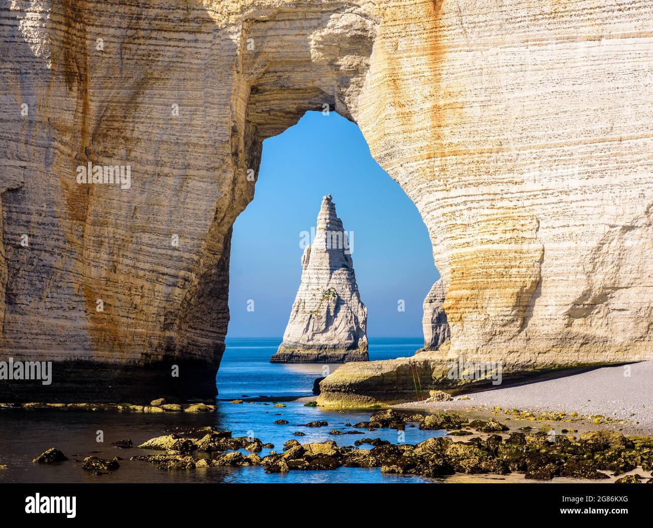 Close-up view of the Needle through the arch of the Manneporte cliff in ...
