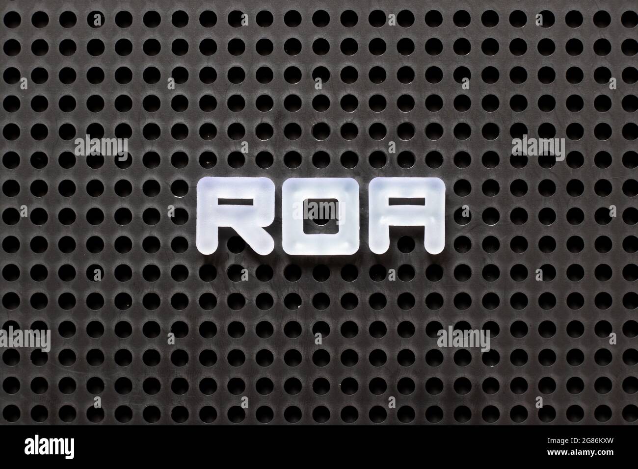 Blank Roa Black color pegboard with white letter in word ROA (Abbbreviation of ...