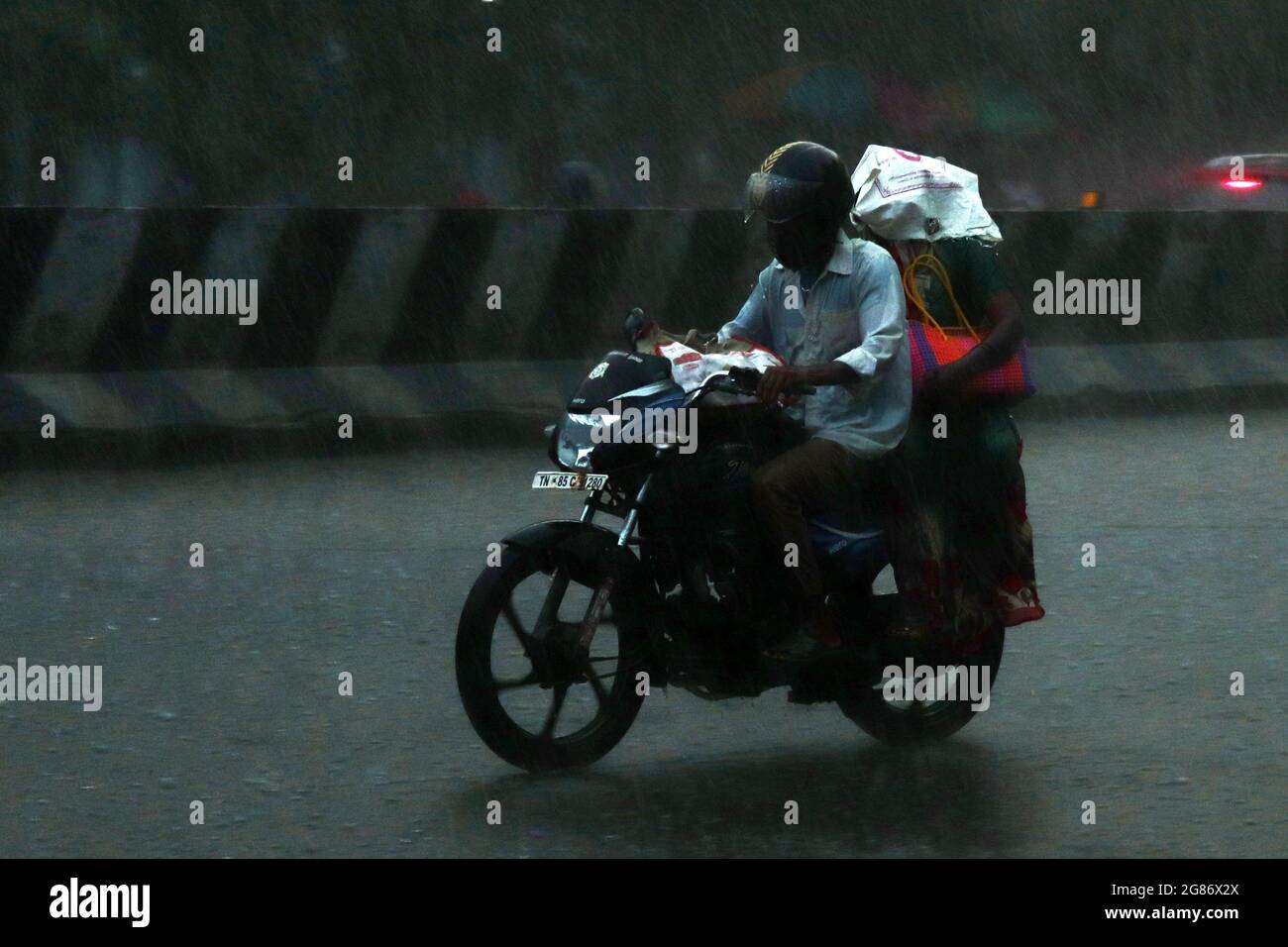 Chennai, Tamil Nadu, India. 17th July, 2021. A man rides his bike on a street under a severe rainfall in Chennai. (Credit Image: © Sri Loganathan/ZUMA Press Wire) Stock Photo