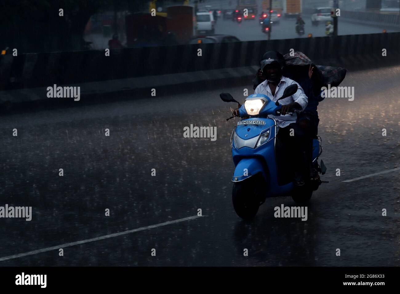 Chennai, Tamil Nadu, India. 17th July, 2021. A man rides his scooter on a street under a severe rainfall in Chennai. (Credit Image: © Sri Loganathan/ZUMA Press Wire) Stock Photo