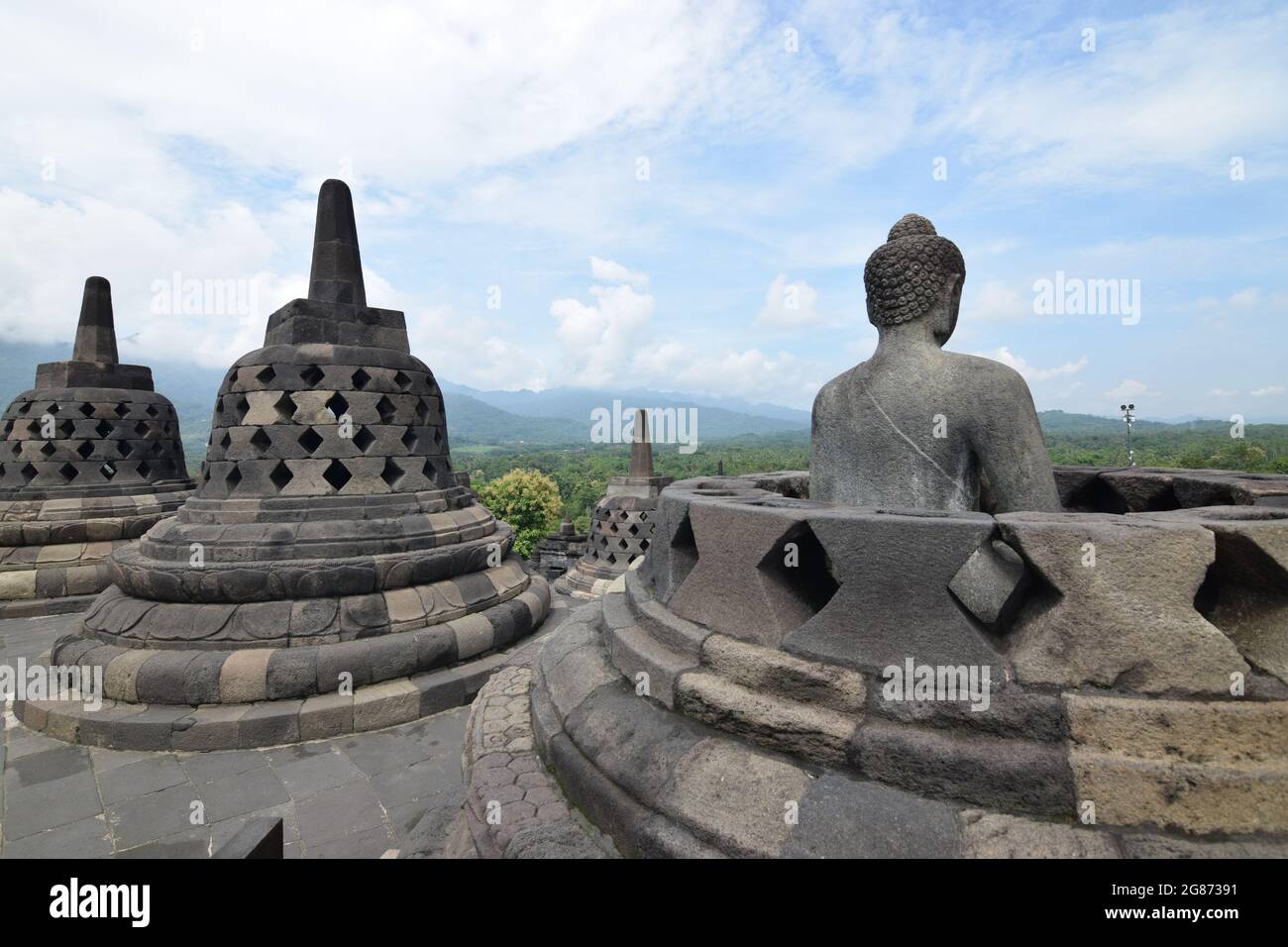 Buddha statue in an open stupa at the Borobudur temple in Java Stock Photo