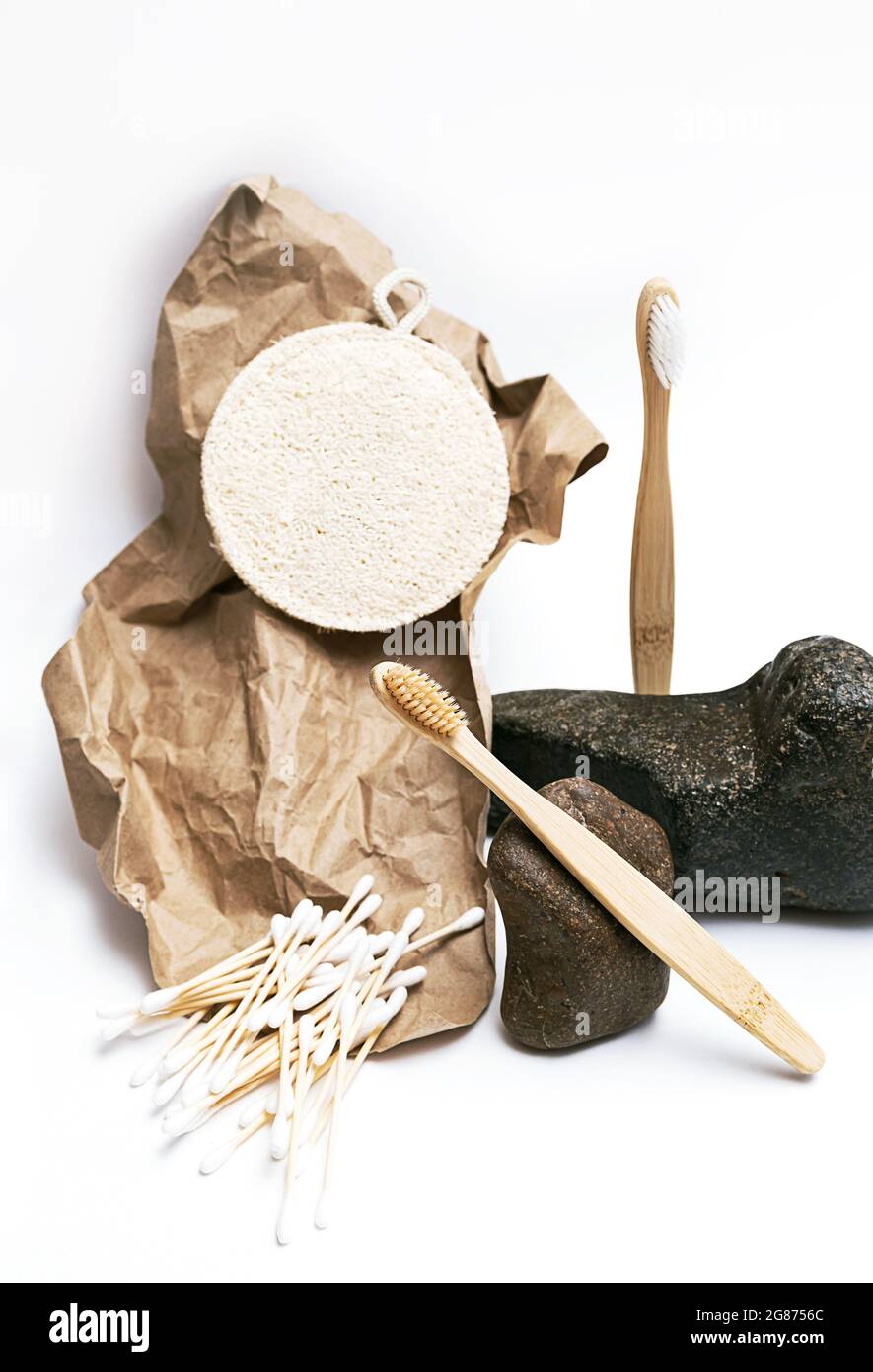 Trendy, minimal still life with natural beauty products and stones. Zero waste bath accessories. Balance composition of bamboo toothbrushes, l Stock Photo
